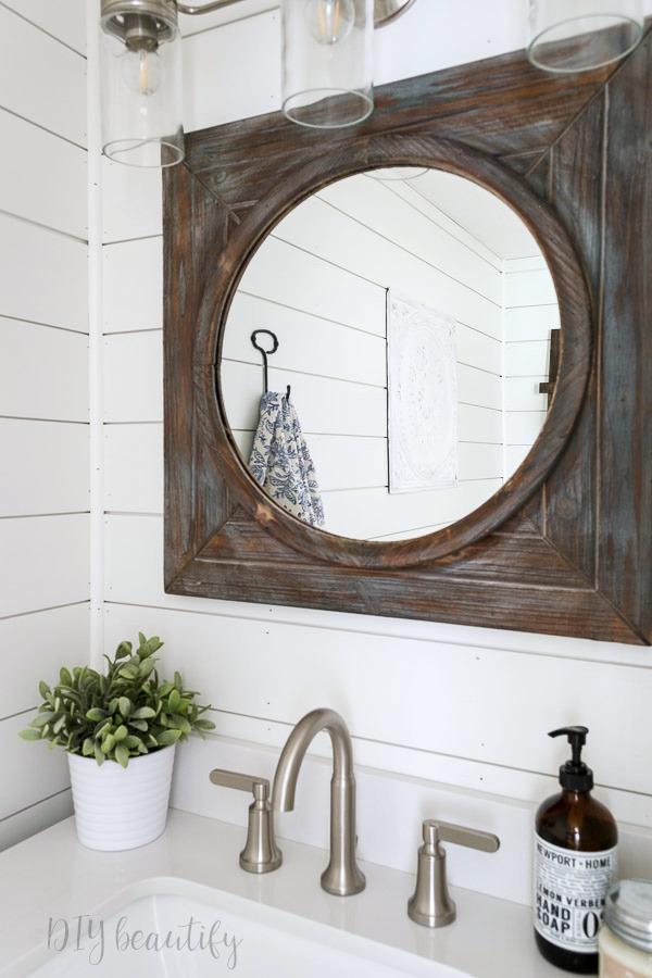 I'm revealing our small bathroom that we made over with products provided by Lowe's to add big farmhouse style! Come see it at DIY beautify! #farmhouse #bathroom #roommakeover #Lowes rustic mirror